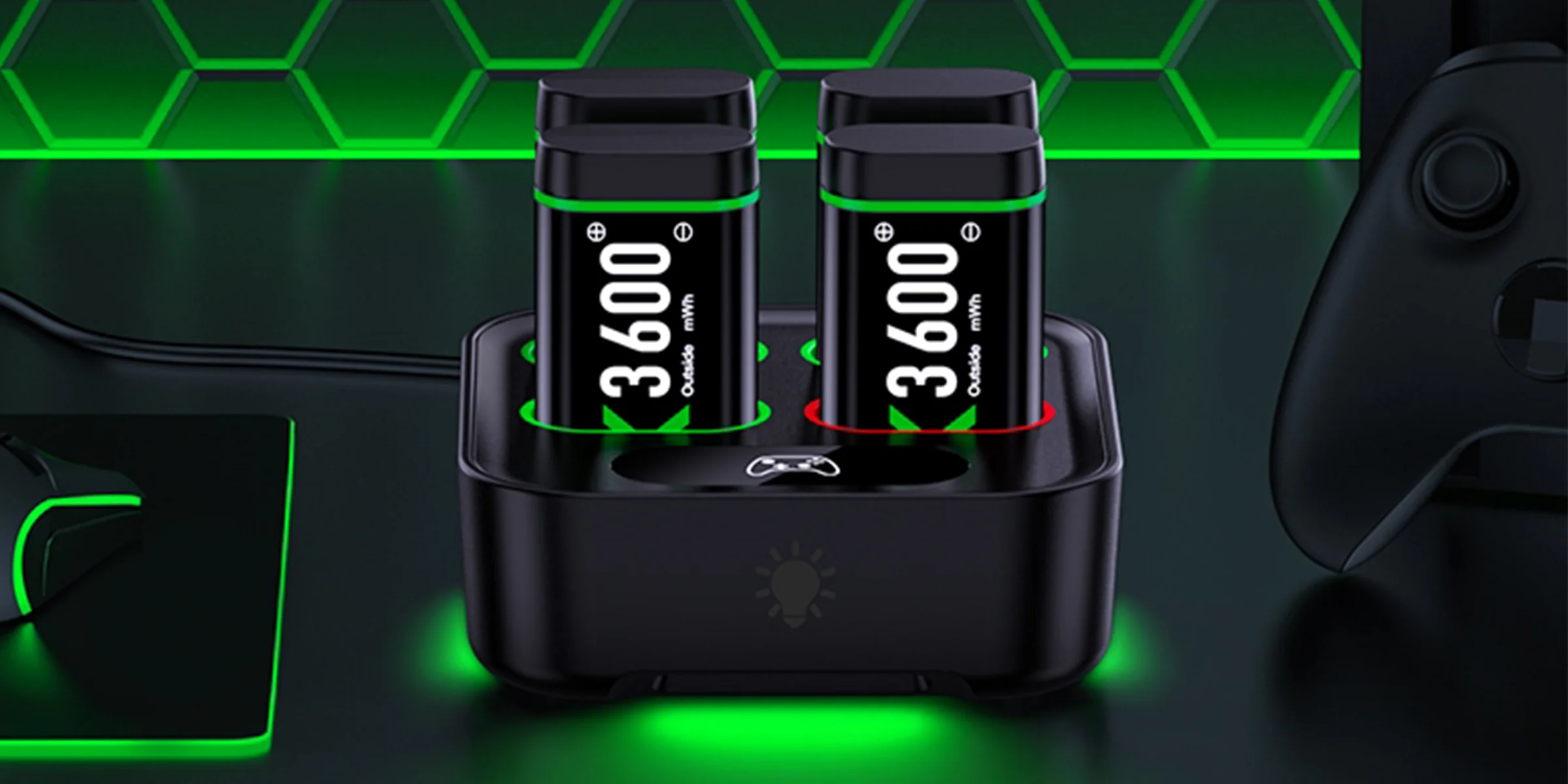 Two 3600 mWh battery packs standing on a charging dock that glows green on a dark desk